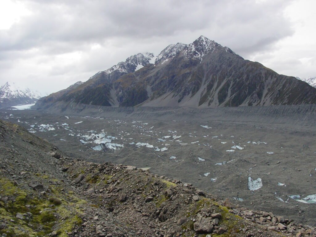 The lower Tasman Glacier, white ice in the far left distance