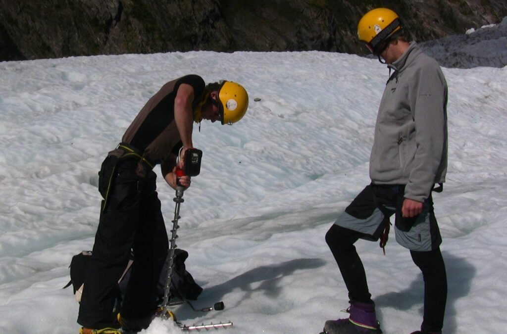 Drilling holes for ablation stakes on Fox Glacier